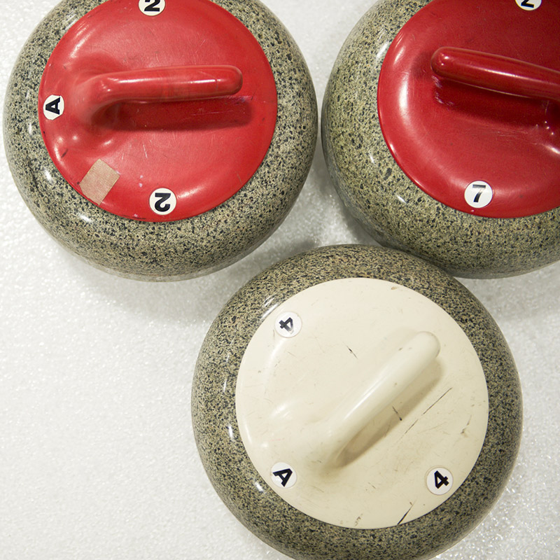 Three curling rocks as seen from above