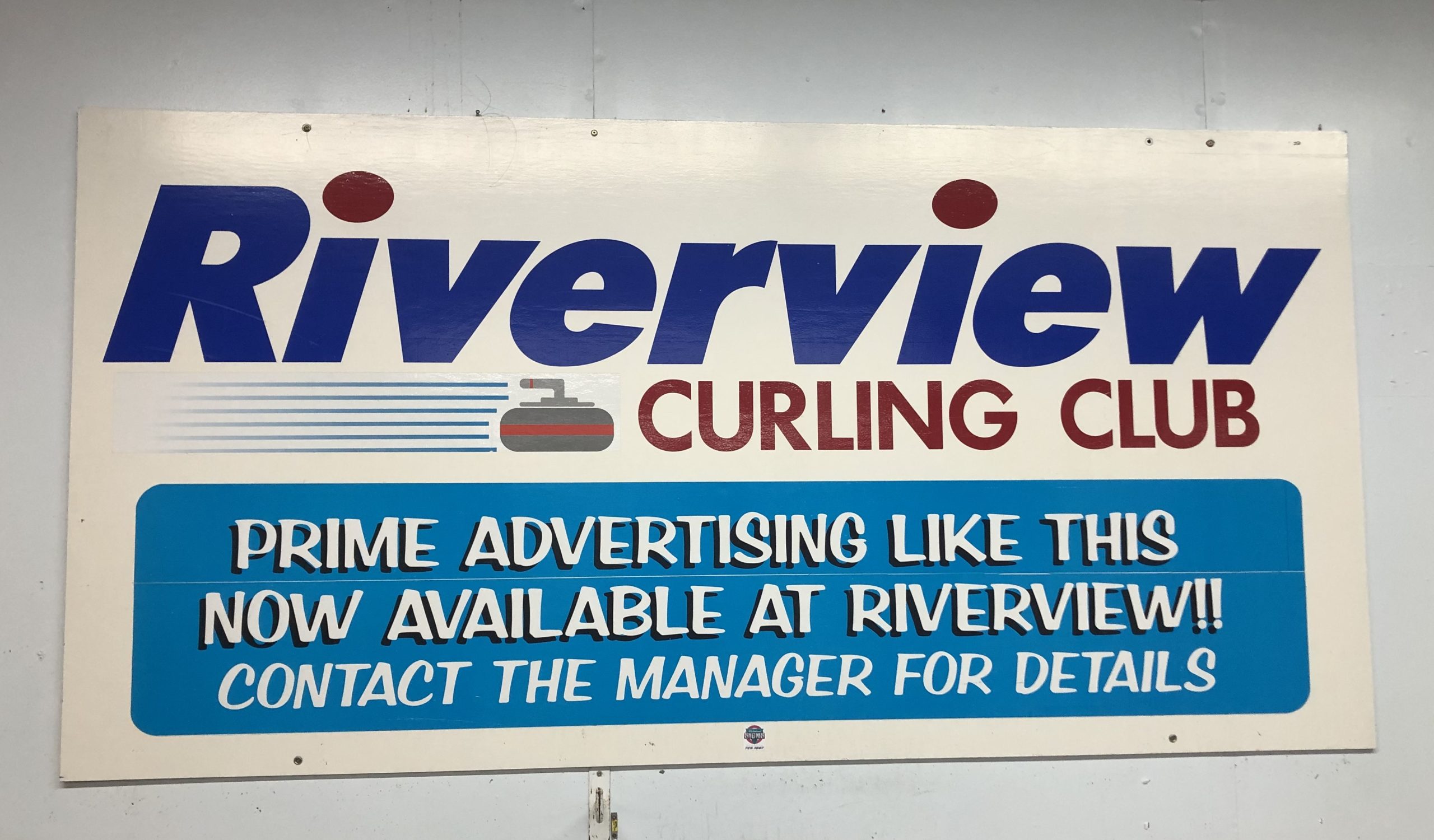 Advertising displayed along the walls of the Riverview Curling Club